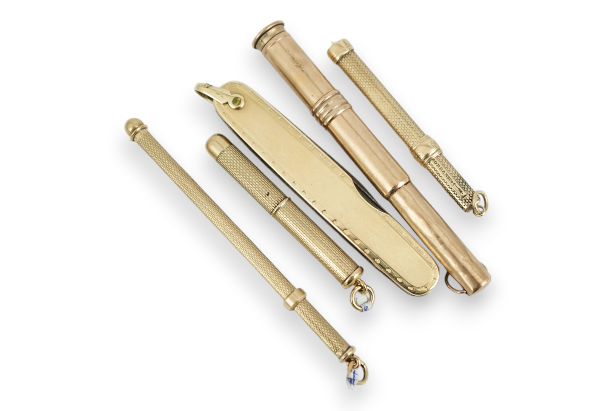 A 9ct mounted cigar piercer, 77mm, a 9ct gold mounted swizzle stick, a yellow metal mounted toothpick, a similar toothpick by S. Mordan & Co and a yellow metal mounted pen knife.